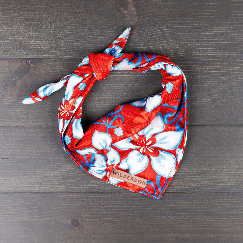 Red and white Aloha Bandana with floral pattern and Smartcart21 tag on dark wooden surface.