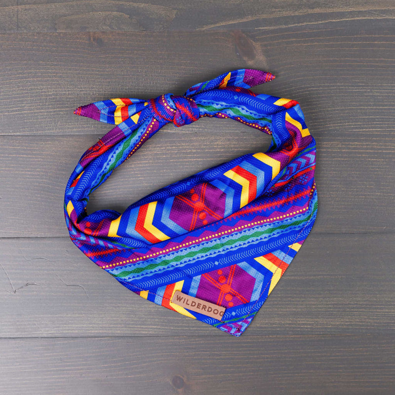 Colorful Big Sky Bandana with geometric pattern and Smartcart21 patch on wooden surface.
