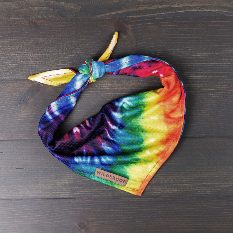 Brightly colored Tiedye Bandana with Smartcart21 tag, tied in knot on dark wooden surface.