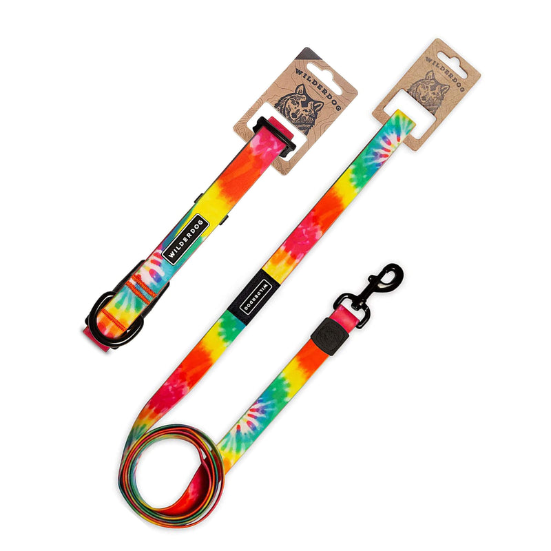 The Tie Dye Waterproof Leash + Collar Bundle (x) features two vibrant leashes with black metal clips and branded tags, shown flat on a white background with cardboard packaging—durable, stylish dog gear for every adventure.