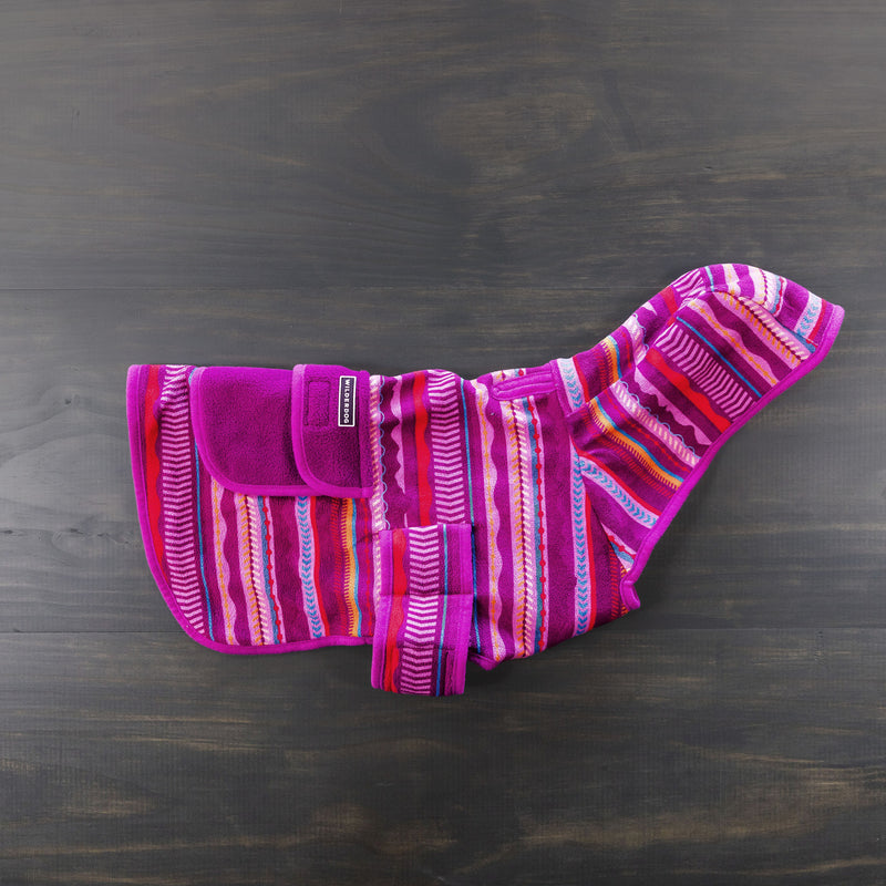 This eye-catching Dawn Fleece Jacket features vibrant horizontal stripes in shades of purple, pink, orange, and white. It comes with a convenient Velcro closure and looks stunning laid flat on a dark wooden surface. Pair it with a Smartcart21 leash for the ultimate walk-ready ensemble.