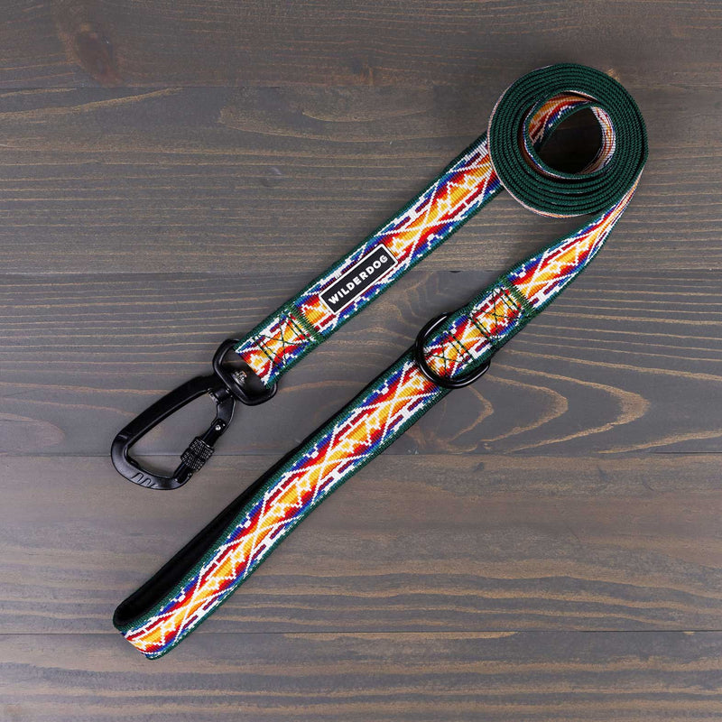 The Rainbow Ultralight Leash from Smartcart21’s Ultralight Collection, featuring a vibrant geometric pattern in red, yellow, green, and blue on a rustic wooden surface. This colorful dog leash includes a black metal clasp and padded handle for both style and comfort.