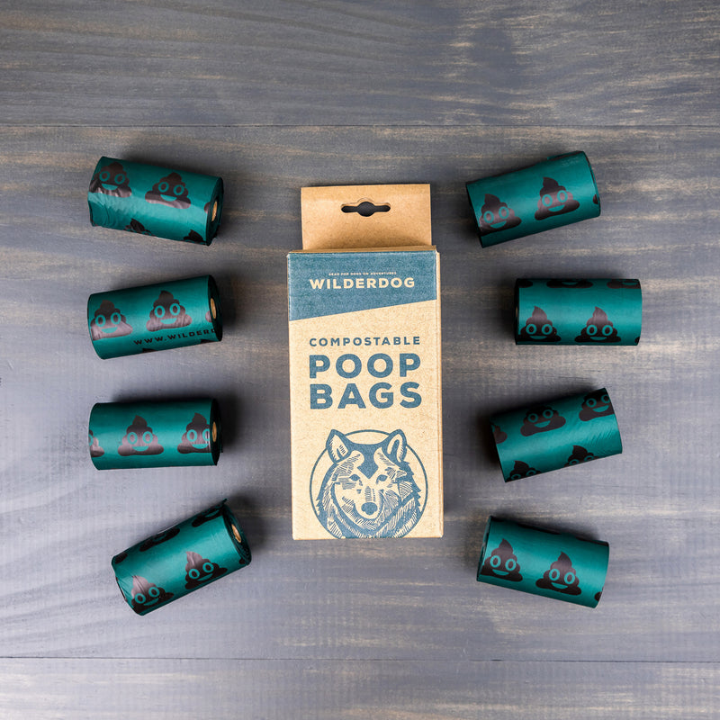 Compostable Dog Poop Bags box with seven green rolls featuring dog face illustrations.