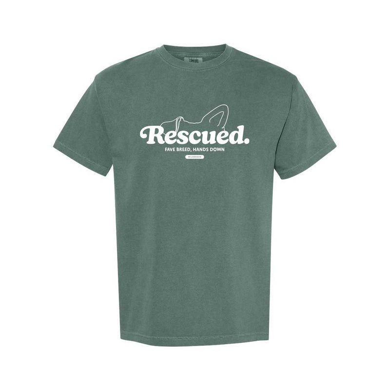 The Smartcart21 Rescue Tee Shirt is a green, garment-dyed heavyweight tee featuring white "Rescued. Fave breed, hands down" text and a dog's head outline above. Sustainably made for comfort and style.