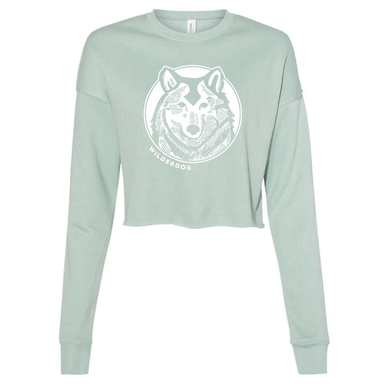 The Smartcart21 Wolf Cropped Sweatshirt is a light green women's top featuring a large white graphic of a wolf's head in the center, with the text "WILDERDOG" printed below. Made from super-soft fleece, this eco-friendly sweatshirt offers long sleeves and a crew neck for ultimate comfort and style.