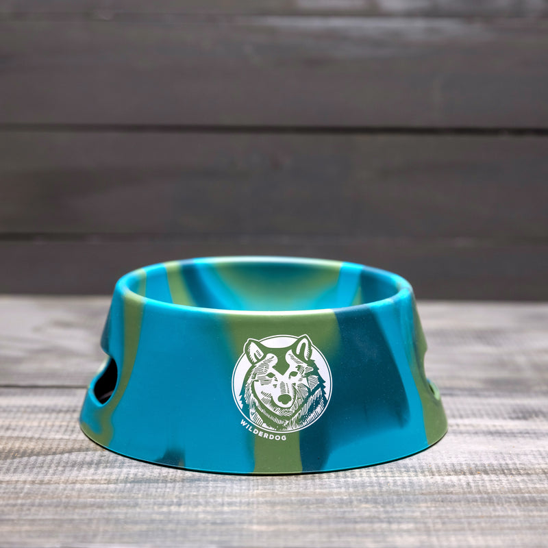 Foldable Silipint Dog Bowl in blue-green camouflage, food-grade silicone, with "Wilderdog" logo.